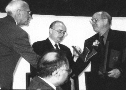 Dr. Braddock on a stage receiving the University Scholar Award from University of Illinois President.